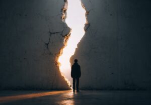 a young adult standing at a cracked