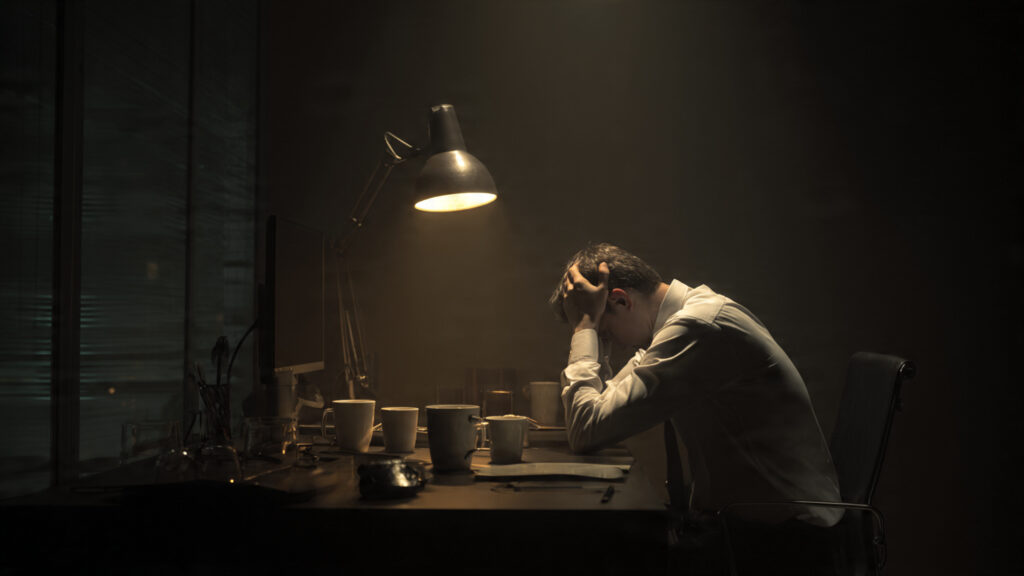 exhausted founder alone in office at night